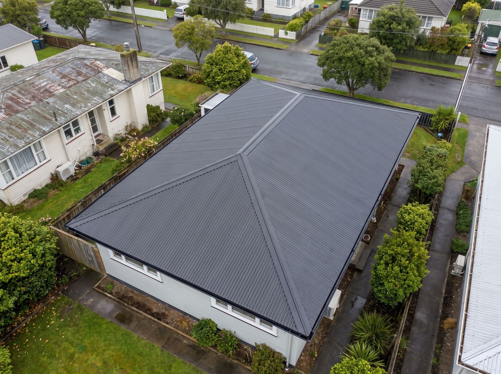 Illustration of a finished re-roof in charcoal COLORSTEEL with new spouting